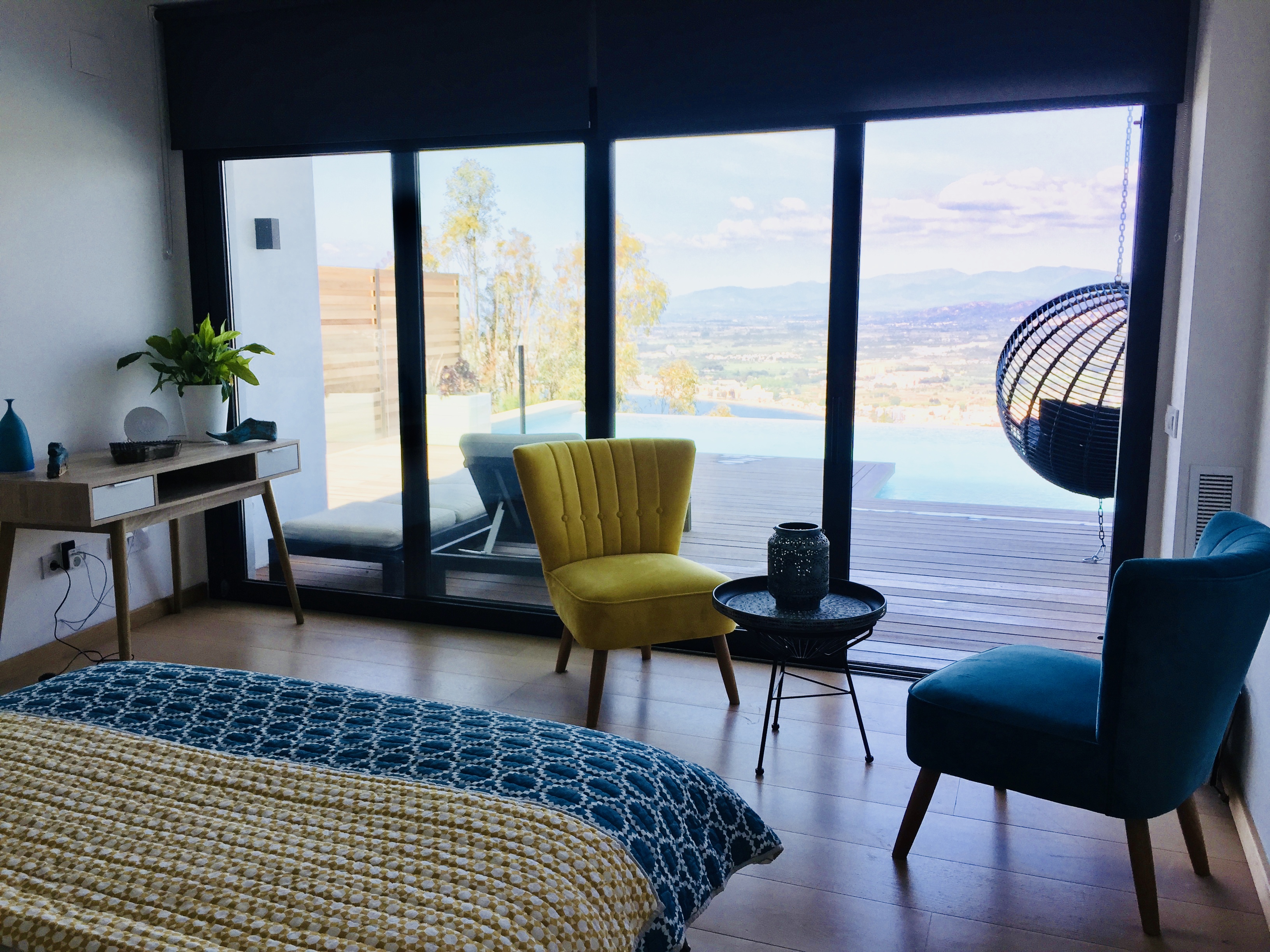 Master bedroom with floor-to-ceiling windows and pool views